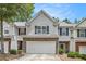 Charming townhome featuring gray siding, brick accents, and a two-car garage in a well-maintained community at 461 Mountain View Ln, Woodstock, GA 30188