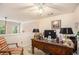 Bright home office with a large desk, ceiling fan, and view to outside, perfect for a work-from-home setup at 461 Mountain View Ln, Woodstock, GA 30188