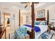 Spacious main bedroom featuring a four-poster bed, ceiling fan, and windows, creating a luxurious retreat at 461 Mountain View Ln, Woodstock, GA 30188