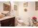 Elegant powder room with granite countertop and dark wood vanity, complemented by stylish decor and a framed oval mirror at 461 Mountain View Ln, Woodstock, GA 30188