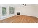 Bright living room with hardwood floors, fireplace, crown molding, and a sliding glass door at 718 Surrey Park Se Pl, Smyrna, GA 30082
