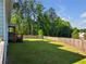 A level backyard featuring a wooden fence, a play structure, and a natural wooded area for privacy at , Kennesaw, GA 30152