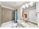 Bathroom with light granite countertops, white cabinetry and a shower with a snowman themed curtain at , Kennesaw, GA 30152
