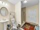 Bathroom featuring tiled floors, a glass shower, pedestal sink and a decorative mirror, which adds a touch of elegance at , Kennesaw, GA 30152