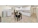 Bright kitchen with white cabinetry, granite countertops, tiled floor, and a dining area that is perfect for gatherings at , Kennesaw, GA 30152