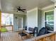 Covered porch with ceiling fan, seating, and wooden deck offers a cozy outdoor living space at , Kennesaw, GA 30152