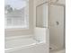 Bathroom featuring a soaking tub and glass-enclosed shower, providing a spa-like experience at 1250 Parkview Nw Ln, Kennesaw, GA 30152