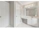 Bright bathroom vanity with white cabinets, countertop, and a large mirror with vanity lighting at 1250 Parkview Nw Ln, Kennesaw, GA 30152
