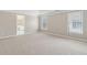Spacious bedroom with neutral paint, plush carpeting, large windows, and an ensuite bathroom for convenience at 1250 Parkview Nw Ln, Kennesaw, GA 30152