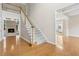 Open foyer with hardwood floors, staircase and view to the formal living room with fireplace at 1250 Parkview Nw Ln, Kennesaw, GA 30152