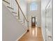 Bright foyer featuring hardwood floors, a wooden staircase, and a front door with glass panels at 1250 Parkview Nw Ln, Kennesaw, GA 30152