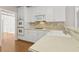 Functional kitchen featuring white cabinets, tile backsplash, and modern appliances at 1250 Parkview Nw Ln, Kennesaw, GA 30152
