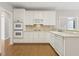 Bright kitchen with white cabinets, stainless steel appliances, and hardwood floors at 1250 Parkview Nw Ln, Kennesaw, GA 30152
