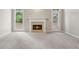 Cozy living room featuring a fireplace, neutral carpet, and natural light from a glass door and window at 1250 Parkview Nw Ln, Kennesaw, GA 30152