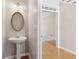 Charming powder room with a pedestal sink and decorative mirror at 1250 Parkview Nw Ln, Kennesaw, GA 30152