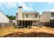 Back exterior featuring a wooden fence, lawn, and sunroom, perfect for outdoor enjoyment and privacy at 1312 Glenover Way, Marietta, GA 30062