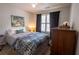 Cozy bedroom with a comfortable bed, soft lighting, and a decorative tree art piece at 1312 Glenover Way, Marietta, GA 30062