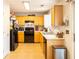 Functional kitchen equipped with essential appliances, light wooden cabinetry and easy-to-clean tile flooring at 1312 Glenover Way, Marietta, GA 30062
