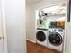 Convenient laundry room closet featuring modern washer and dryer on hardwood floor at 1312 Glenover Way, Marietta, GA 30062