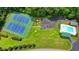 Aerial view of a community recreational area with tennis courts, a basketball court, and a swimming pool at 1592 Walkway Ct, Lilburn, GA 30047