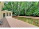 A home's wood deck overlooking a wooded area at 1592 Walkway Ct, Lilburn, GA 30047