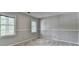 Cozy bedroom features two windows, chair rail, and neutral carpet at 1592 Walkway Ct, Lilburn, GA 30047