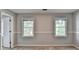 Cozy bedroom features two windows and chair rail at 1592 Walkway Ct, Lilburn, GA 30047
