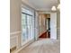 Bright dining space with an open view of connecting rooms, featuring chair rail molding and a modern chandelier at 1592 Walkway Ct, Lilburn, GA 30047