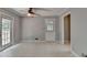 View of the dining room with gray walls, neutral floors and a double door leading to an outside deck at 1592 Walkway Ct, Lilburn, GA 30047