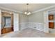 Cozy dining area with chair rail, multiple entryways to adjacent rooms, and a modern chandelier at 1592 Walkway Ct, Lilburn, GA 30047