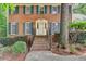 Charming brick stairway leading to the front door, framed by lush landscaping and classic shutters at 1592 Walkway Ct, Lilburn, GA 30047