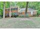 Two-story brick home with manicured landscaping, complemented by dark green shutters on a sunny day at 1592 Walkway Ct, Lilburn, GA 30047