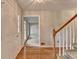 Inviting foyer featuring hardwood floors, a staircase, and a view into a bright, open living space at 1592 Walkway Ct, Lilburn, GA 30047