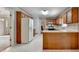 Traditional kitchen features wooden cabinets, a double basin sink, white countertops and a refrigerator at 1592 Walkway Ct, Lilburn, GA 30047