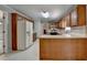 Traditional kitchen features wooden cabinets, a double basin sink beneath a window, and white countertops at 1592 Walkway Ct, Lilburn, GA 30047