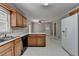 Traditional kitchen features wooden cabinets and white countertops, with a dining area visible beyond at 1592 Walkway Ct, Lilburn, GA 30047