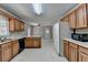Spacious kitchen with wooden cabinets and view to another room at 1592 Walkway Ct, Lilburn, GA 30047