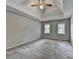 Spacious main bedroom features two windows, neutral carpet, and a tray ceiling with ceiling fan at 1592 Walkway Ct, Lilburn, GA 30047