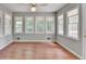 Sun room has wood flooring and multiple windows at 1592 Walkway Ct, Lilburn, GA 30047