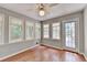 Sun room has wood flooring, view to deck and multiple windows at 1592 Walkway Ct, Lilburn, GA 30047