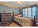 Cozy bedroom with a comfortable bed, dresser and a large window with natural light at 4969 Truitt Ln, Decatur, GA 30035