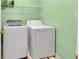 Laundry room featuring modern washer and dryer units, and shelving for storage at 4969 Truitt Ln, Decatur, GA 30035