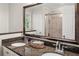 Bathroom vanity with dual sinks, granite countertop and a view of the shower area at 100 Parkerwood Way, Alpharetta, GA 30022