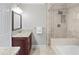Bathroom with a glass-enclosed shower/tub, granite vanity, and neutral tiling at 100 Parkerwood Way, Alpharetta, GA 30022