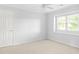Empty room with neutral walls, one window and a door that would make a great bedroom at 100 Parkerwood Way, Alpharetta, GA 30022