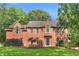Charming brick home with lush lawn and landscaping at 100 Parkerwood Way, Alpharetta, GA 30022