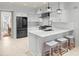 Modern kitchen features stainless steel appliances, island with seating, white cabinets and marble countertops at 100 Parkerwood Way, Alpharetta, GA 30022