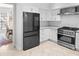 This stunning kitchen features stainless appliances, tile backsplash, and white cabinets with gold hardware at 100 Parkerwood Way, Alpharetta, GA 30022