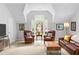 Bright living room with vaulted ceilings, large windows, and comfortable seating at 100 Parkerwood Way, Alpharetta, GA 30022