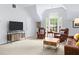 Bright living room with vaulted ceilings, large windows, and comfortable seating at 100 Parkerwood Way, Alpharetta, GA 30022